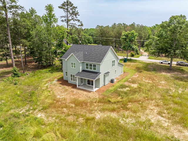 651 Moose Club Rd, Thomson, GA 30824 - rear view of house featuring a shingled roof, a garage, and a patio area