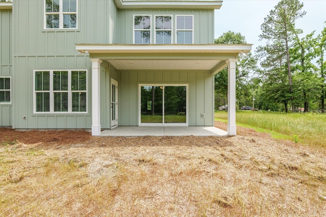 651 Moose Club Rd, Thomson, GA 30824 - back of property with board and batten siding and a patio
