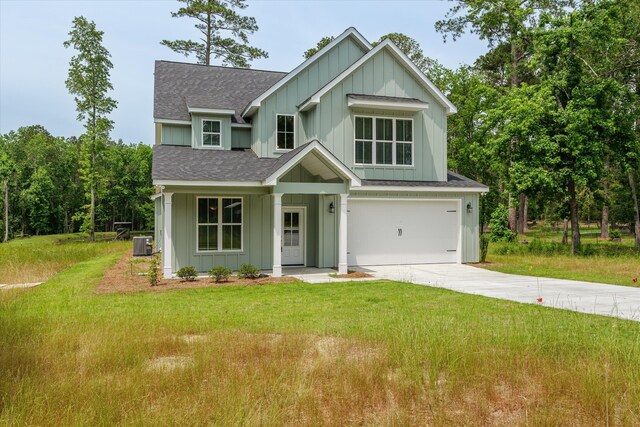651 Moose Club Rd, Thomson, GA 30824 - view of front facade with board and batten siding, a shingled roof, central AC, driveway, and a garage