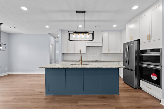 651 Moose Club Rd, Thomson, GA 30824 - kitchen with freestanding refrigerator, double oven, a sink, baseboards, and white cabinetry
