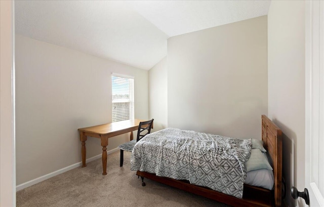 bedroom featuring carpet flooring, baseboards, and vaulted ceiling