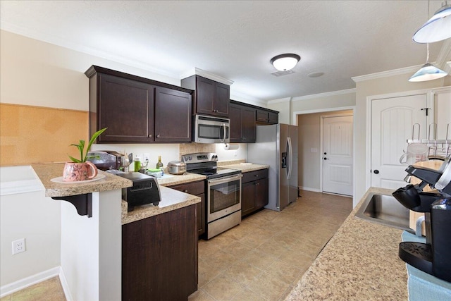 kitchen with ornamental molding, dark brown cabinetry, light countertops, appliances with stainless steel finishes, and pendant lighting