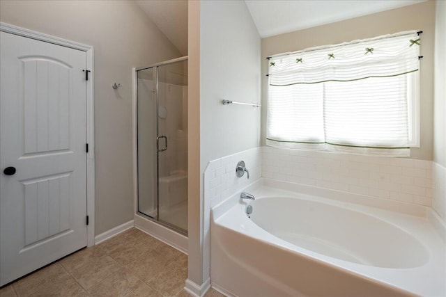 full bath featuring tile patterned flooring, a bath, and a stall shower