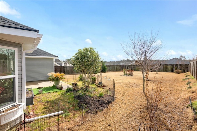 view of yard featuring a vegetable garden and a fenced backyard