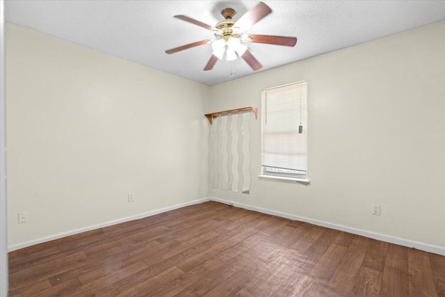 unfurnished room with dark hardwood / wood-style floors, ceiling fan, and a textured ceiling