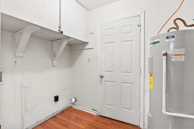 washroom with water heater and light wood-type flooring