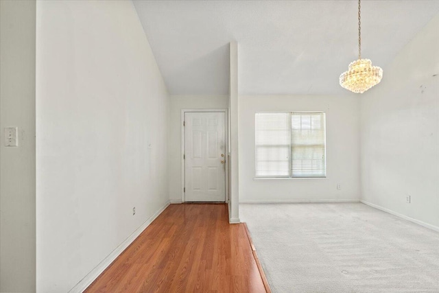 interior space featuring wood-type flooring and a notable chandelier