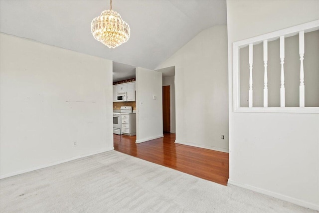 unfurnished living room with light carpet, an inviting chandelier, and lofted ceiling