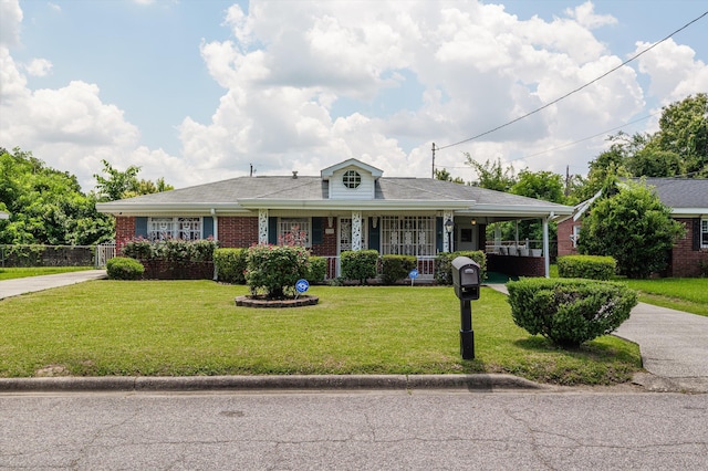 118 E Hale St, Augusta, GA 30901 - view of front of house with a porch, a front lawn, brick siding, and concrete driveway