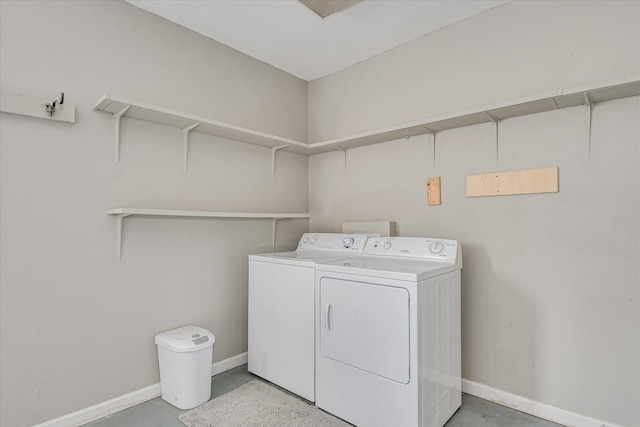 laundry area with independent washer and dryer and baseboards