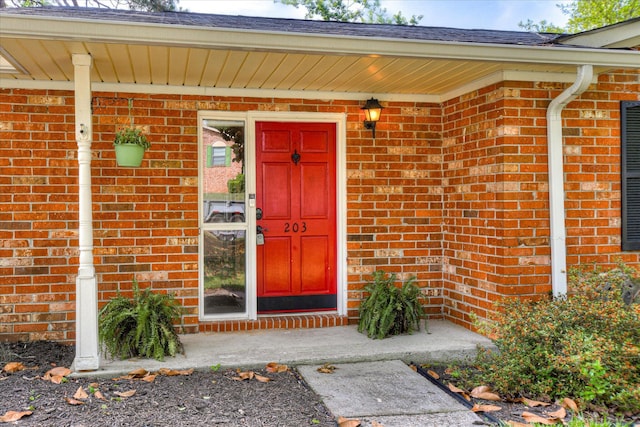 property entrance with brick siding