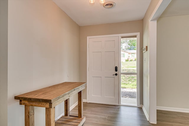 entryway with wood finished floors and baseboards