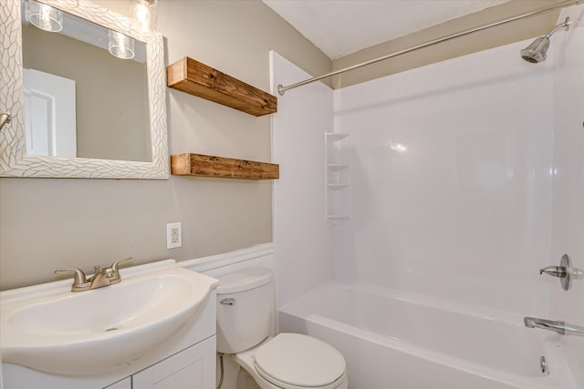 bathroom featuring toilet, vanity, and tub / shower combination