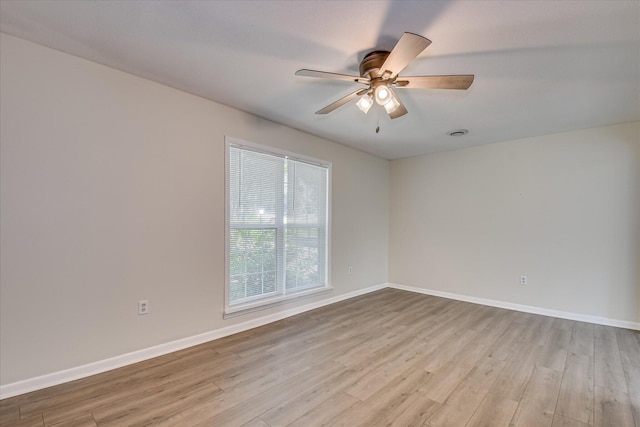 empty room featuring light wood-type flooring, ceiling fan, and baseboards