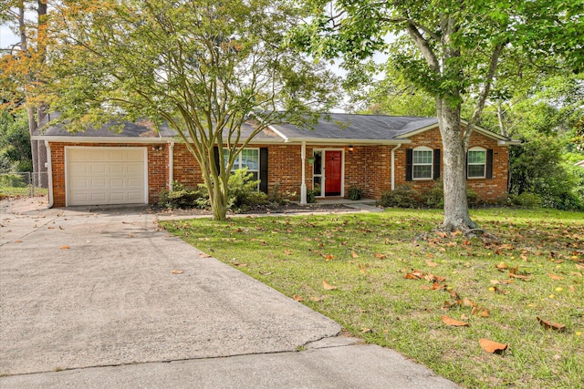ranch-style home featuring concrete driveway, brick siding, an attached garage, and a front lawn