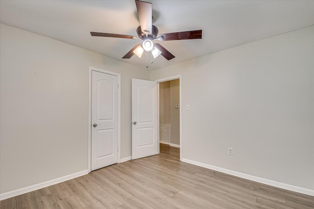 unfurnished bedroom with light wood-style floors, baseboards, and ceiling fan