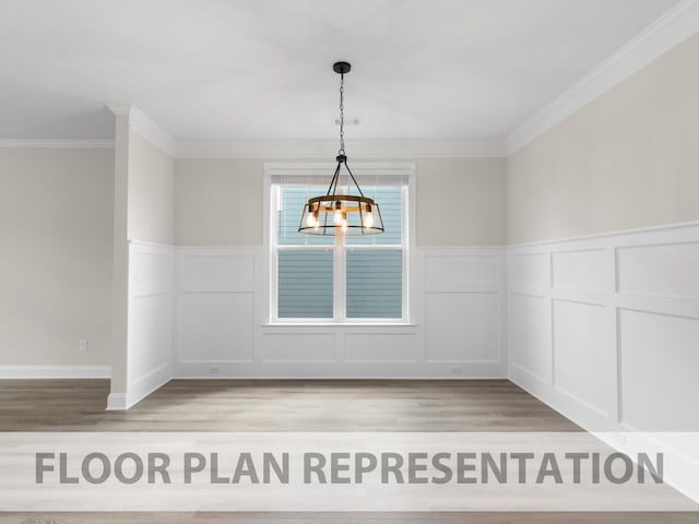 unfurnished dining area featuring crown molding, a notable chandelier, a decorative wall, and light wood finished floors