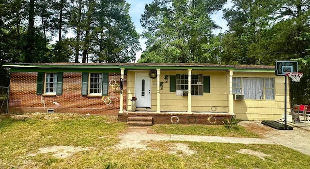 view of front of home with cooling unit and a front lawn