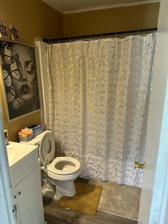 bathroom with crown molding, vanity, wood-type flooring, curtained shower, and toilet