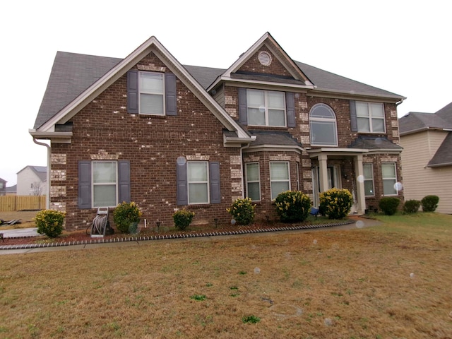 view of front of home with brick siding and a front yard