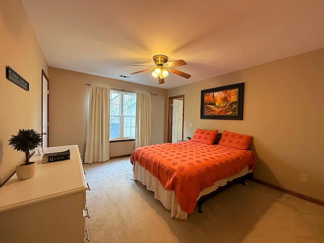 bedroom with baseboards, visible vents, light carpet, and ceiling fan