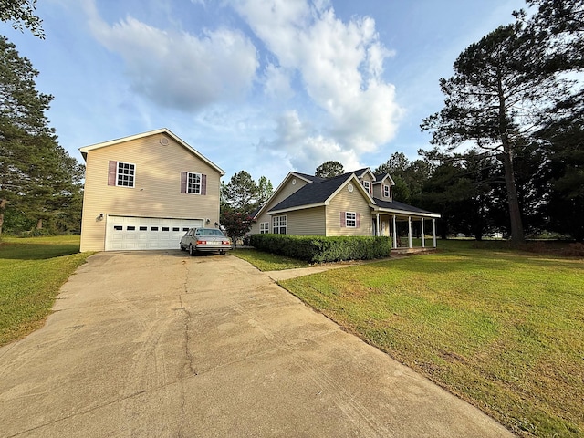 view of front of home featuring a front lawn, concrete driveway, and an attached garage
