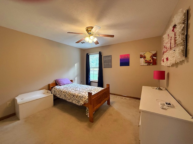 bedroom with light colored carpet, a ceiling fan, and baseboards