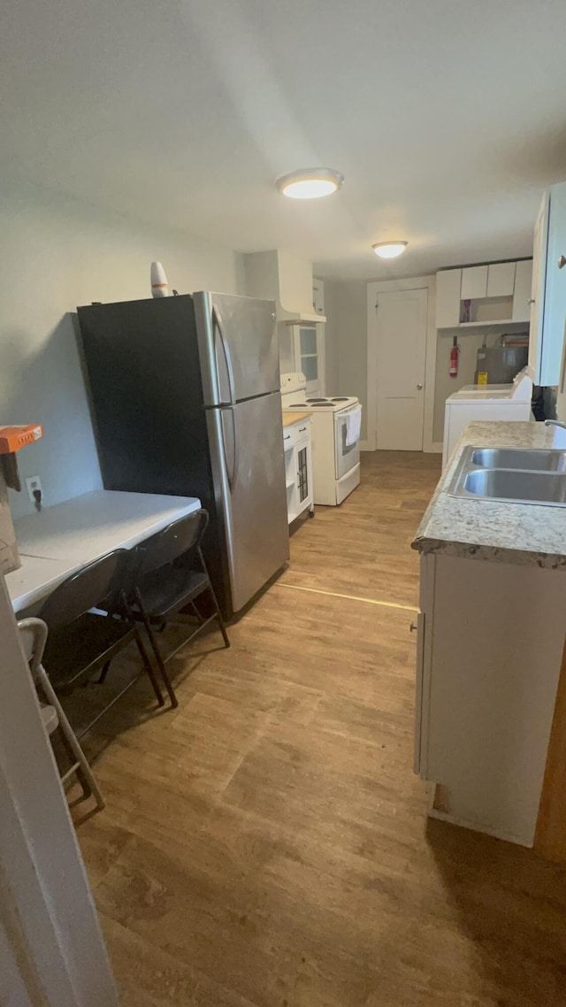 118 W Robinson Ave, Grovetown, GA 30813 - kitchen featuring white electric range, white cabinets, light wood-type flooring, a sink, and washer / clothes dryer