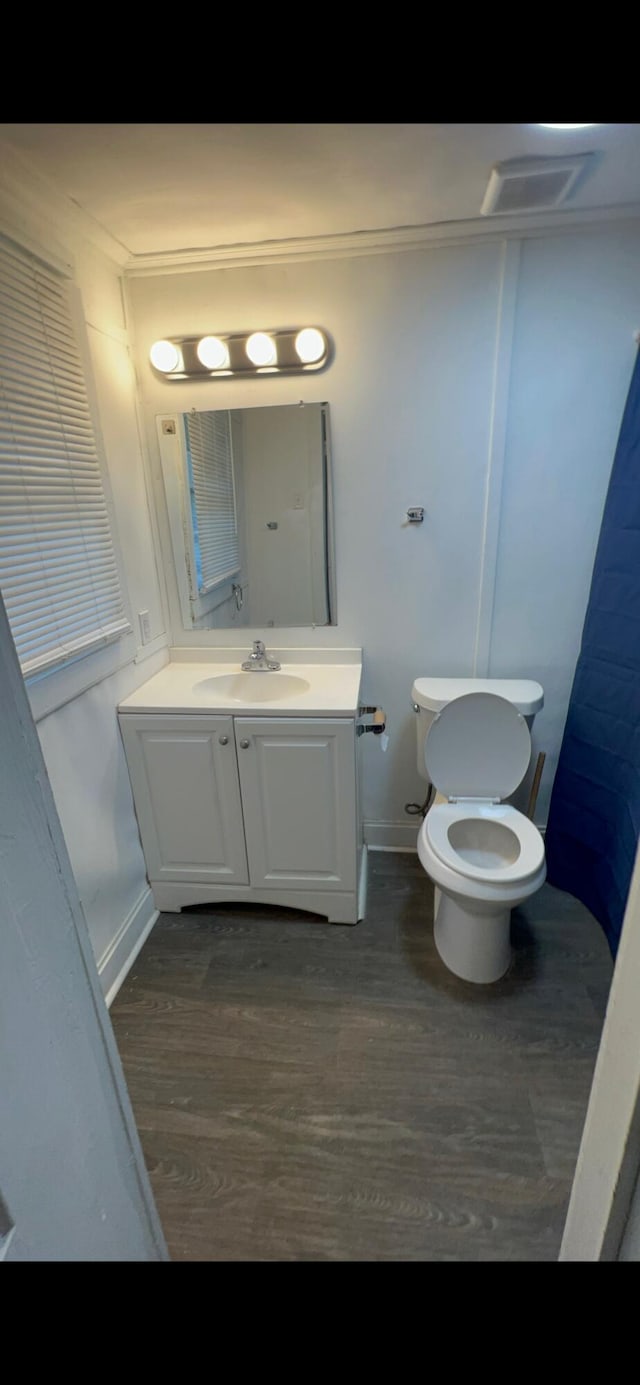 118 W Robinson Ave, Grovetown, GA 30813 - bathroom featuring wood finished floors, toilet, vanity, and baseboards