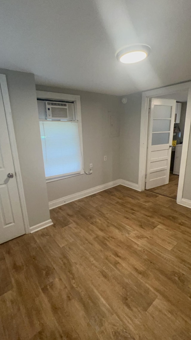 118 W Robinson Ave, Grovetown, GA 30813 - unfurnished bedroom with wood finished floors, baseboards, and a wall mounted AC