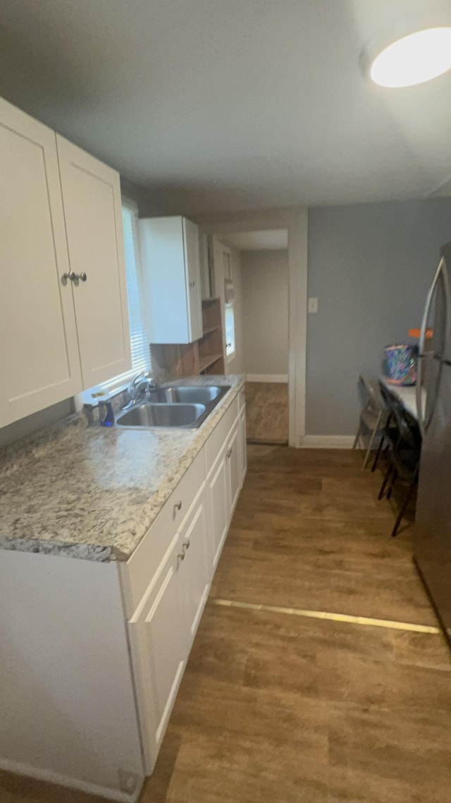 118 W Robinson Ave, Grovetown, GA 30813 - kitchen featuring a sink, freestanding refrigerator, white cabinetry, wood finished floors, and baseboards