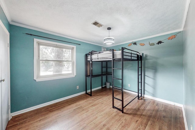 503 Mckenzie Ct, North Augusta, SC 29841 - unfurnished bedroom featuring crown molding, wood finished floors, and a textured ceiling