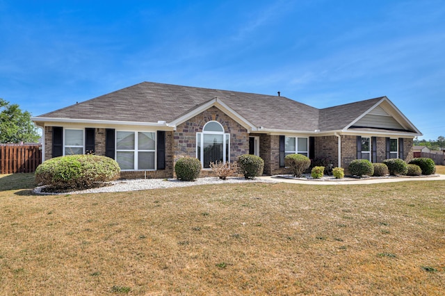 2731 Ashton Dr, Hephzibah, GA 30815 - ranch-style house with brick siding, fence, a shingled roof, and a front lawn