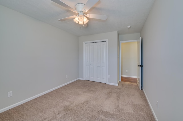 2731 Ashton Dr, Hephzibah, GA 30815 - unfurnished bedroom with light colored carpet, a ceiling fan, baseboards, and a closet