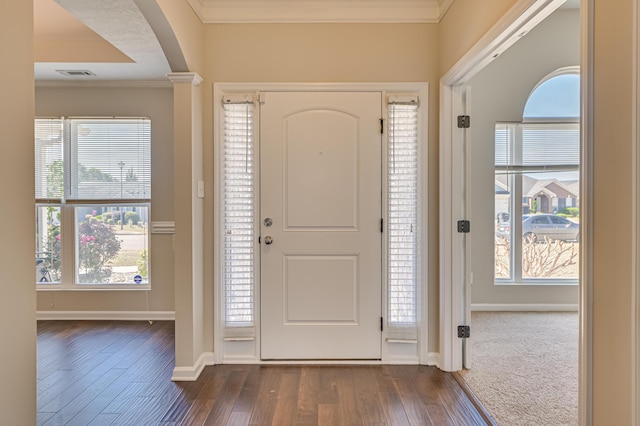 2731 Ashton Dr, Hephzibah, GA 30815 - entryway with arched walkways, dark wood finished floors, baseboards, visible vents, and ornamental molding