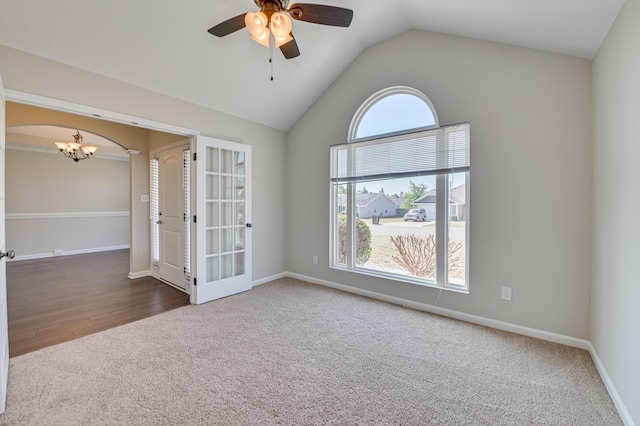 2731 Ashton Dr, Hephzibah, GA 30815 - carpeted spare room featuring french doors, arched walkways, baseboards, ceiling fan with notable chandelier, and lofted ceiling