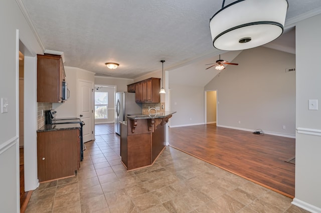 2731 Ashton Dr, Hephzibah, GA 30815 - kitchen with decorative backsplash, a ceiling fan, stainless steel microwave, electric stove, and open floor plan