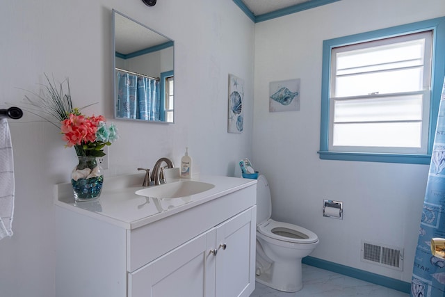 bathroom featuring vanity, toilet, and crown molding