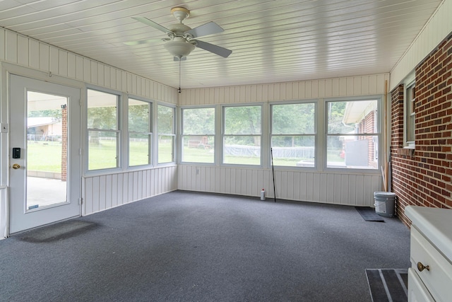 unfurnished sunroom with ceiling fan and plenty of natural light