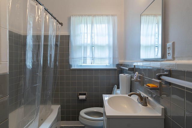 full bathroom with shower / bath combination with curtain, toilet, tile walls, and vanity