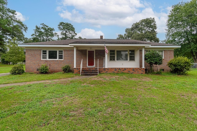 ranch-style home featuring a front yard