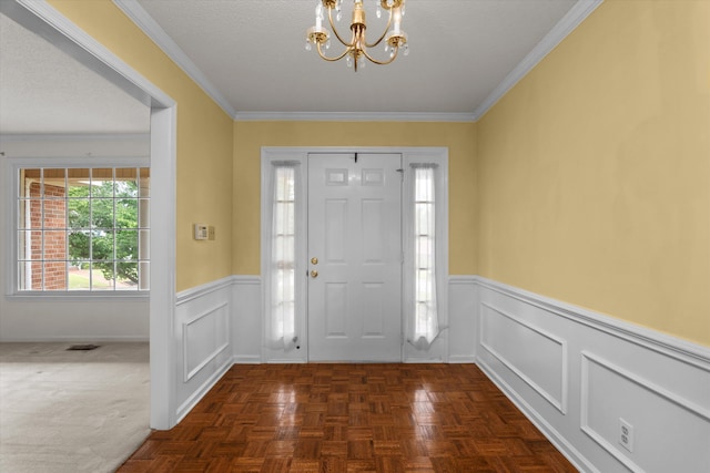 114 Sigman Pl, Martinez, GA 30907 - foyer entrance featuring a chandelier, wainscoting, crown molding, and a decorative wall