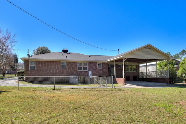 back of house featuring an attached carport, a yard, and fence