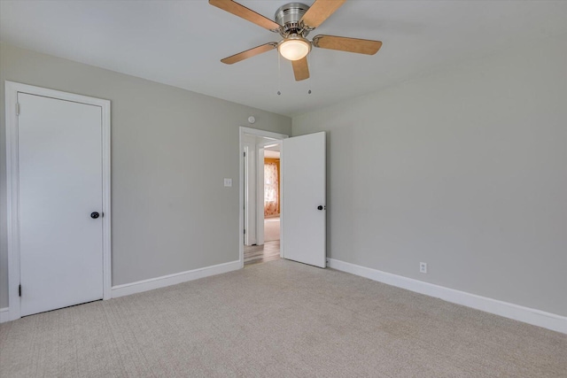 unfurnished bedroom with light colored carpet, baseboards, and ceiling fan