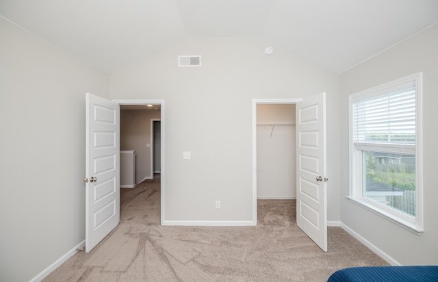 6047 Bakerville Ln, North Augusta, SC 29860 - unfurnished bedroom with a walk in closet, carpet floors, lofted ceiling, and a closet