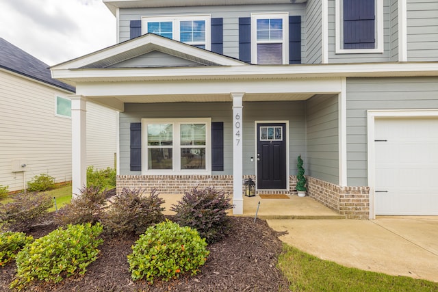 6047 Bakerville Ln, North Augusta, SC 29860 - property entrance featuring covered porch, brick siding, and a garage