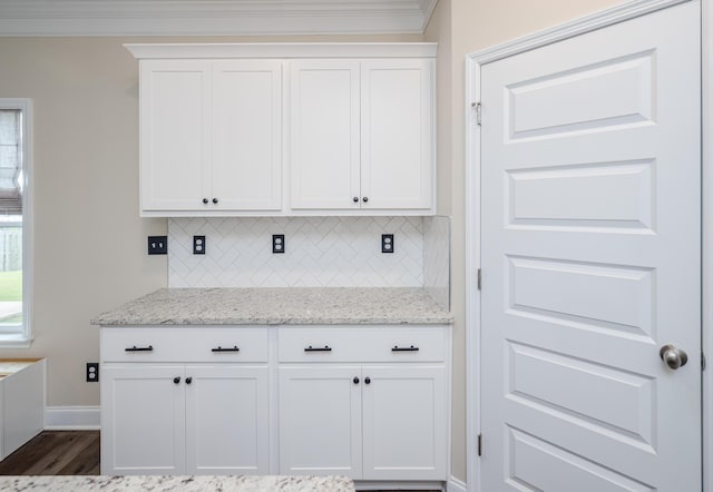6047 Bakerville Ln, North Augusta, SC 29860 - kitchen featuring backsplash, white cabinets, ornamental molding, light stone counters, and dark wood-style flooring