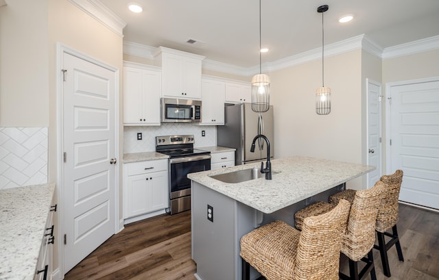 6047 Bakerville Ln, North Augusta, SC 29860 - kitchen with appliances with stainless steel finishes, ornamental molding, dark wood-type flooring, a breakfast bar, and backsplash