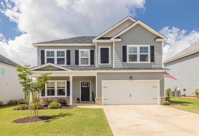 6047 Bakerville Ln, North Augusta, SC 29860 - craftsman house featuring board and batten siding, a front yard, an attached garage, driveway, and brick siding