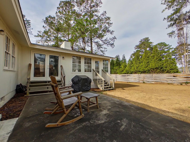 view of patio / terrace featuring entry steps, french doors, area for grilling, and a fenced backyard